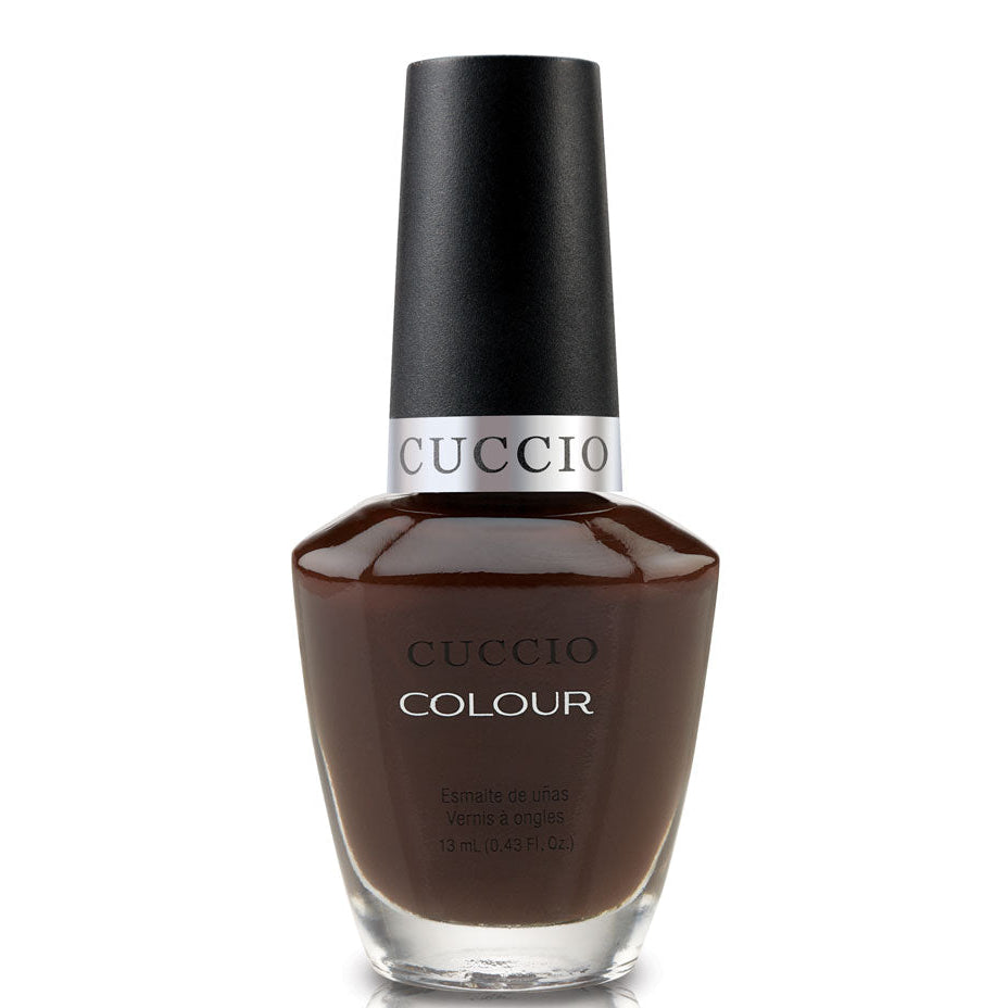 Cuccio nail polish bottle with brown color on a white background