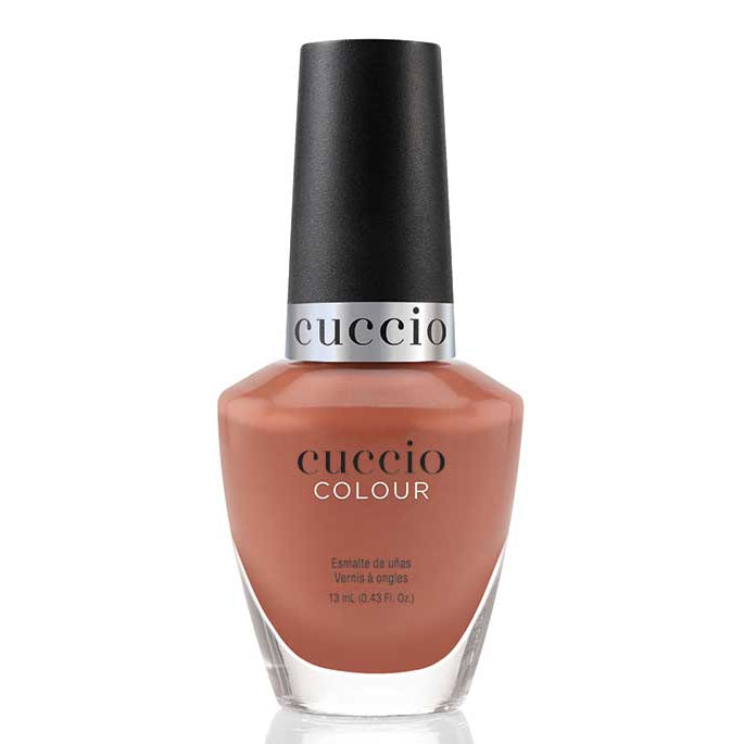 Cuccio nail polish bottle with a brown color on a white background