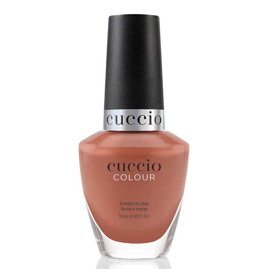 Cuccio nail polish bottle with a brown color on a white background