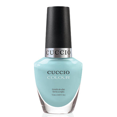 Cuccio nail polish bottle with a light green color on a white background