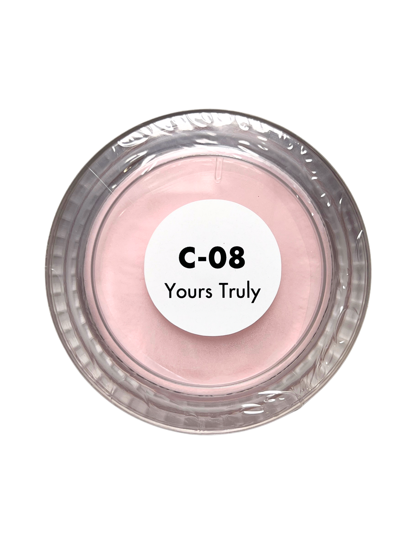 Small container of pink powder with a label on a white background