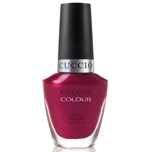 Cuccio nail polish bottle with a magenta color on a white background