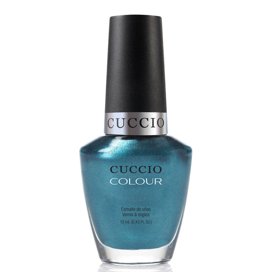 Cuccio nail polish bottle with metallic blue color on a white background