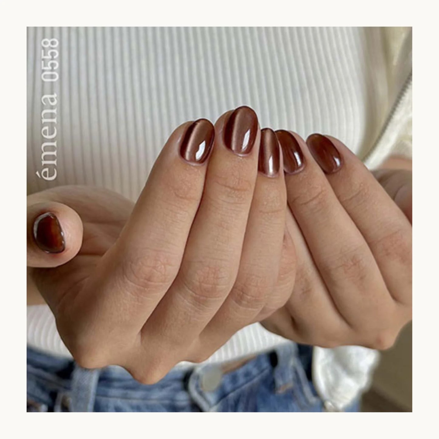 Close-up of hands with brown nail polish against a neutral background