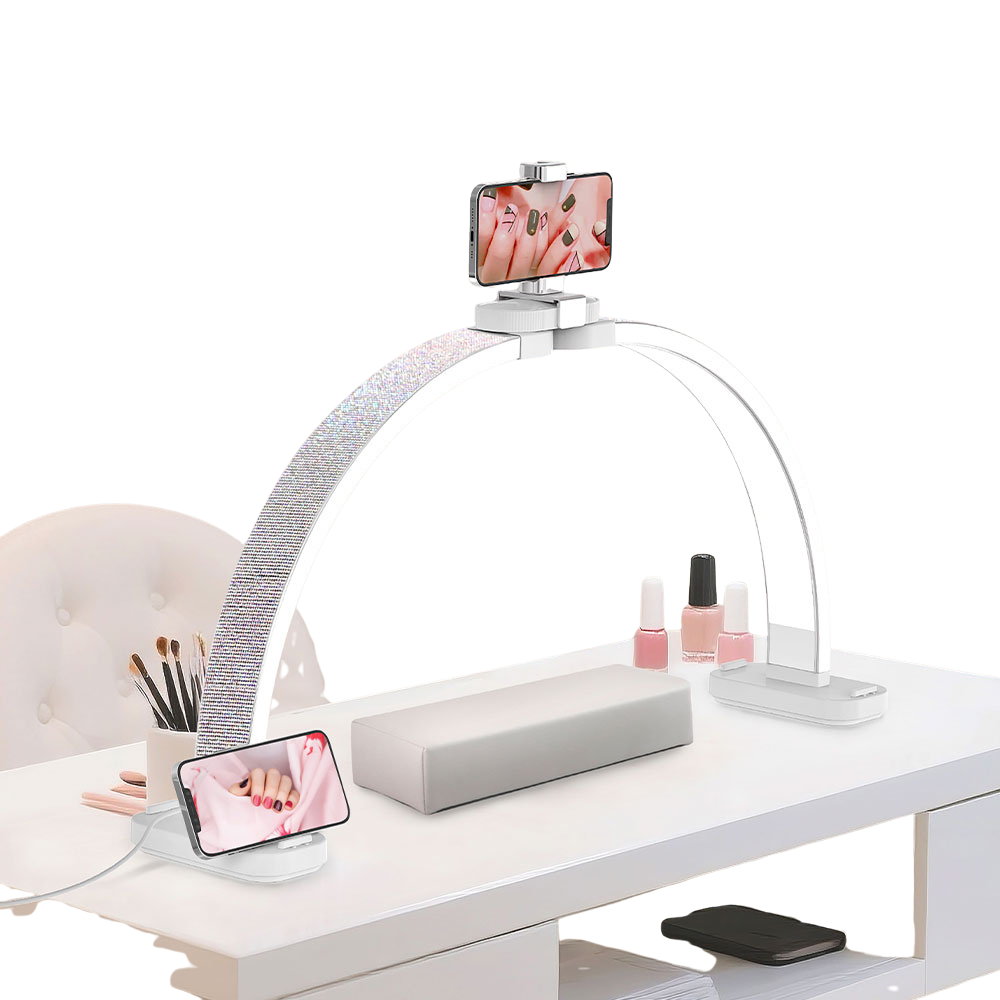 rhinestone desk lamp with a phone holder at the top, a phone stand on the bottom left and right of the lamp base, on a white desk, over a white background