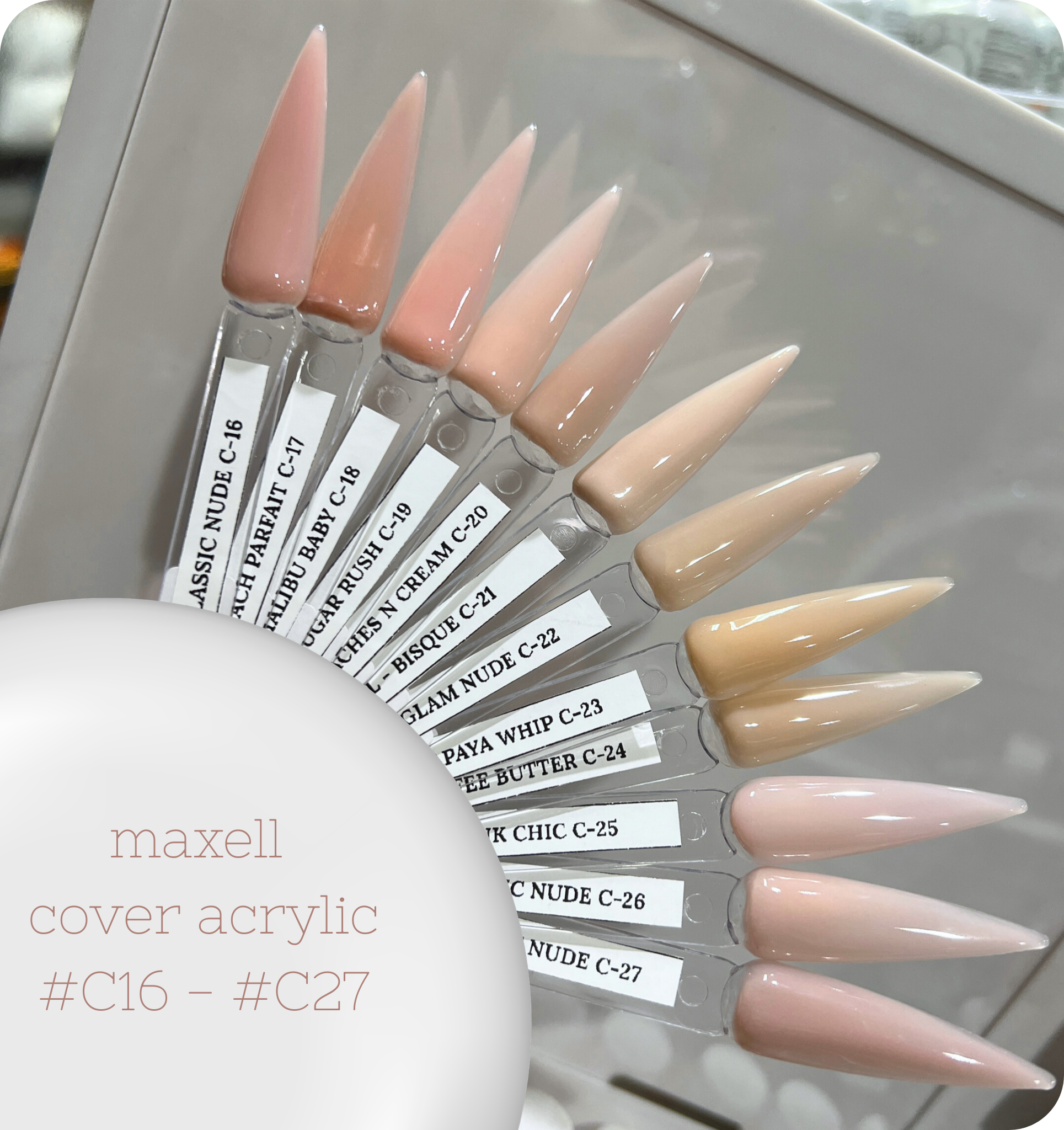 Maxell cover acrylic nail samples in various shades on a stand.