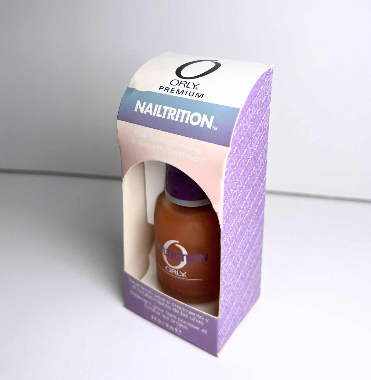 nail polish bottle inside purple colored paper box labeled nailtrition on a white background