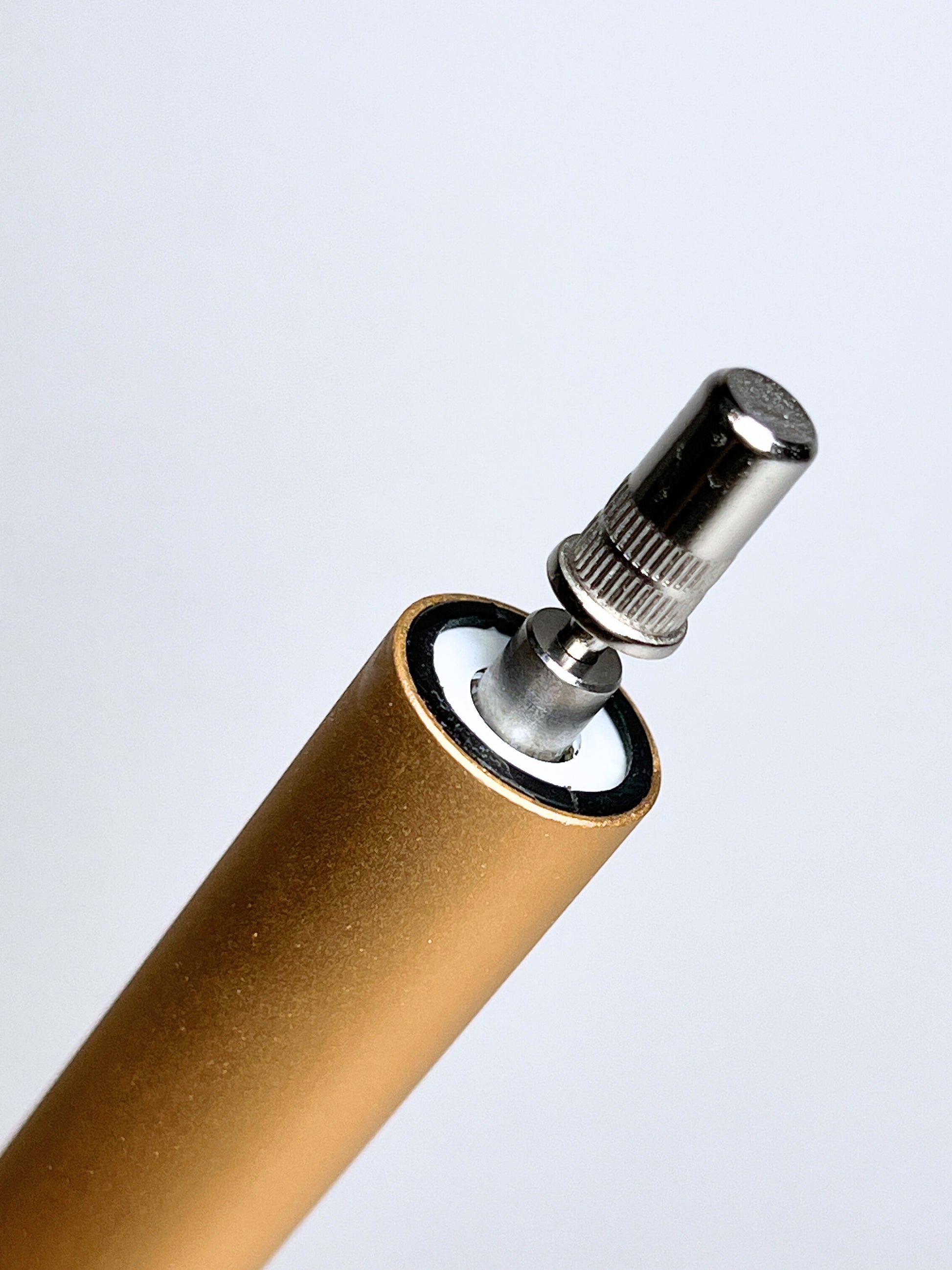 gold nail drill close up of bit change