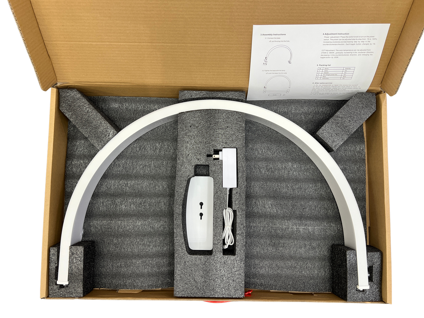 Product packaging with a curved white desk lamp, power adapter, and cable inside a cardboard box.