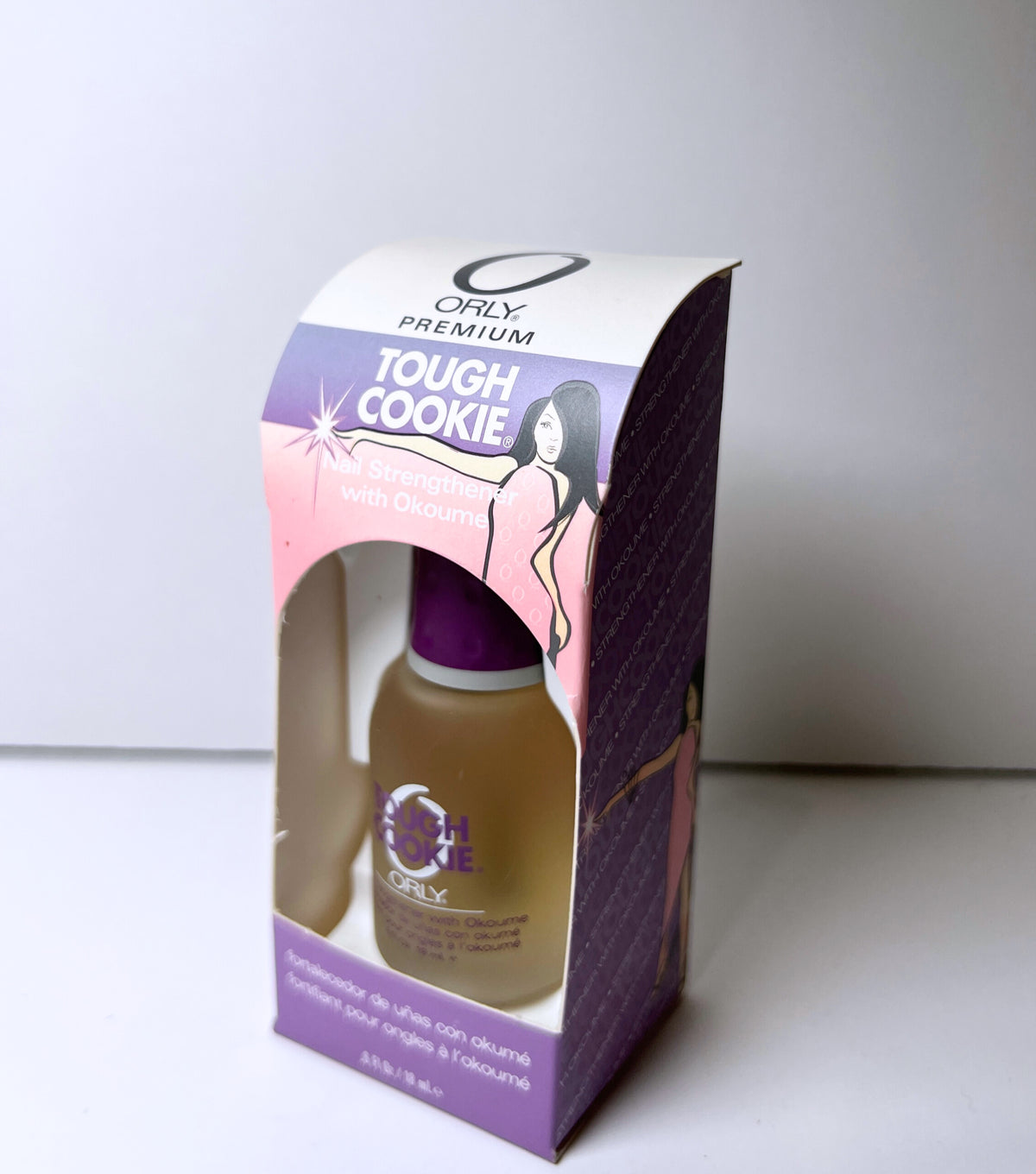 nail polish inside purple and pink colored product box with a white background