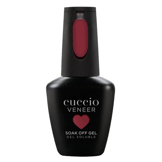 Cuccio Veneer soak off gel bottle with red nail polish on a white background